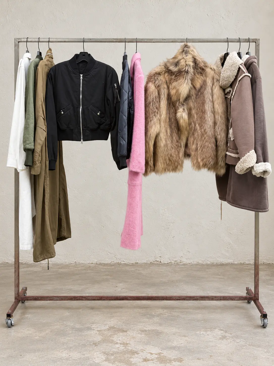 Bomber jackets, coats and textured outerwear on a garment rack