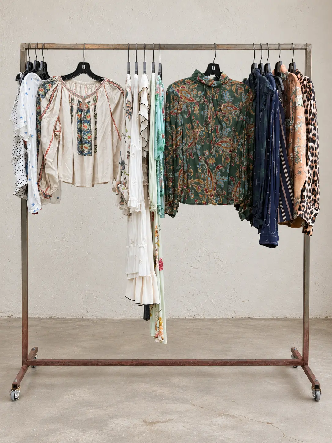 Printed blouses and patterned garments on a garment rack